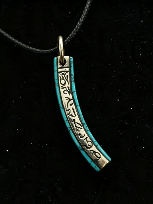 A turquoise and silver crescent-shaped pendant necklace with engraved script, hanging from a black cord against a black background.